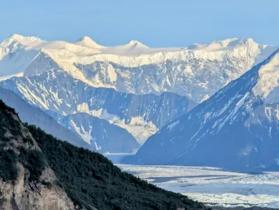 Zoomed in view of the ice field and snowpack atop the mountains, and how thick it is.