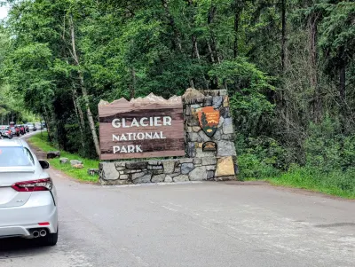 Glacier National Park entry sign, and a long line to get in the park
