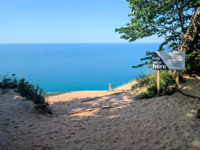 At the top of another dune in the eventing and witnessing a young couple decide to make the several hundred foot decent down the dune.