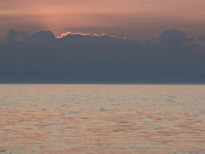 The sun disappearing behind the clouds
