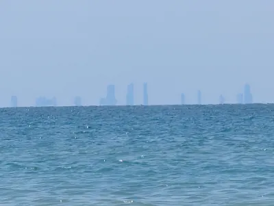 Zoomed in shot of the Chicago skyline just sticking over the horizon