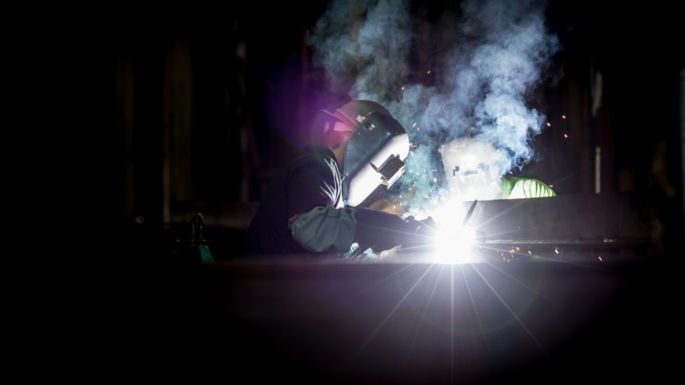Two welders at work, sparks flying