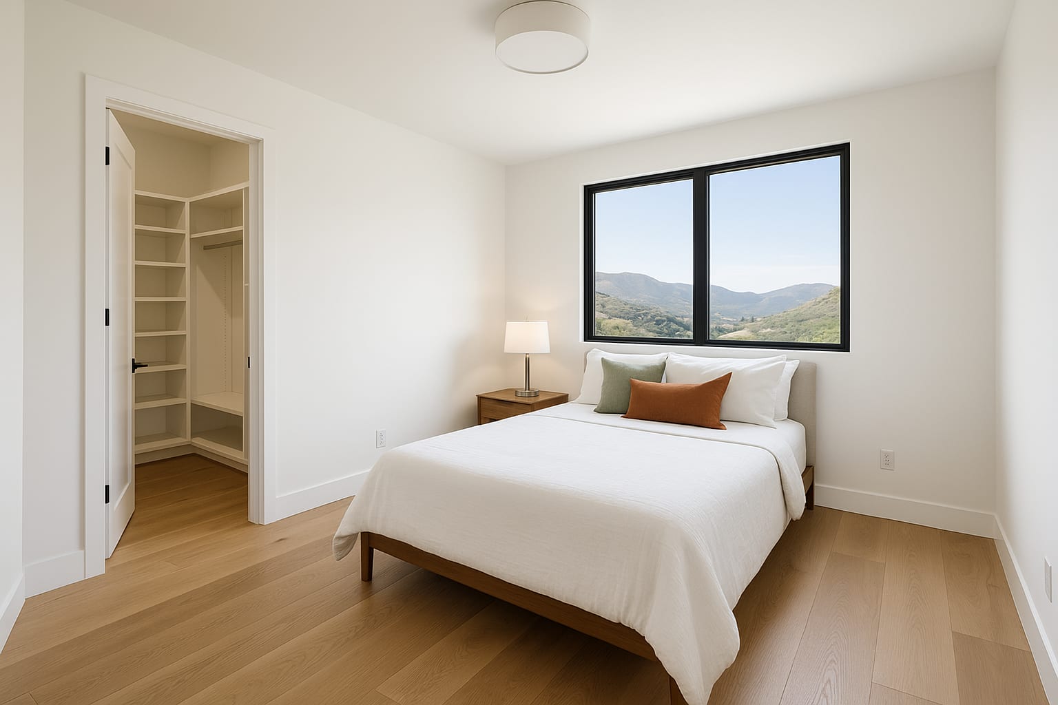 Secondary bedroom with walk-in closet and mountain views
