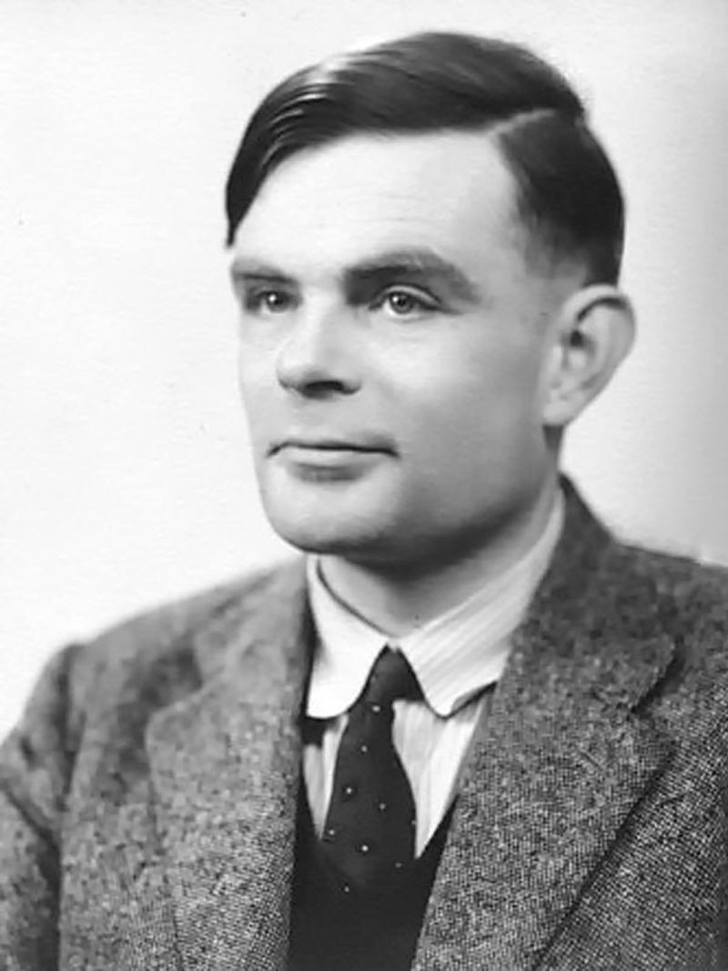Historical black and white portrait of Alan Turing, computer science pioneer, serious expression and dark jacket