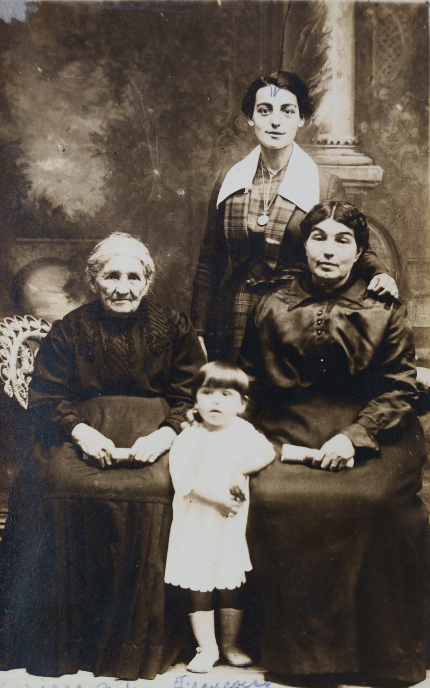 Old photos of four generations of women showing yellowing and scratches