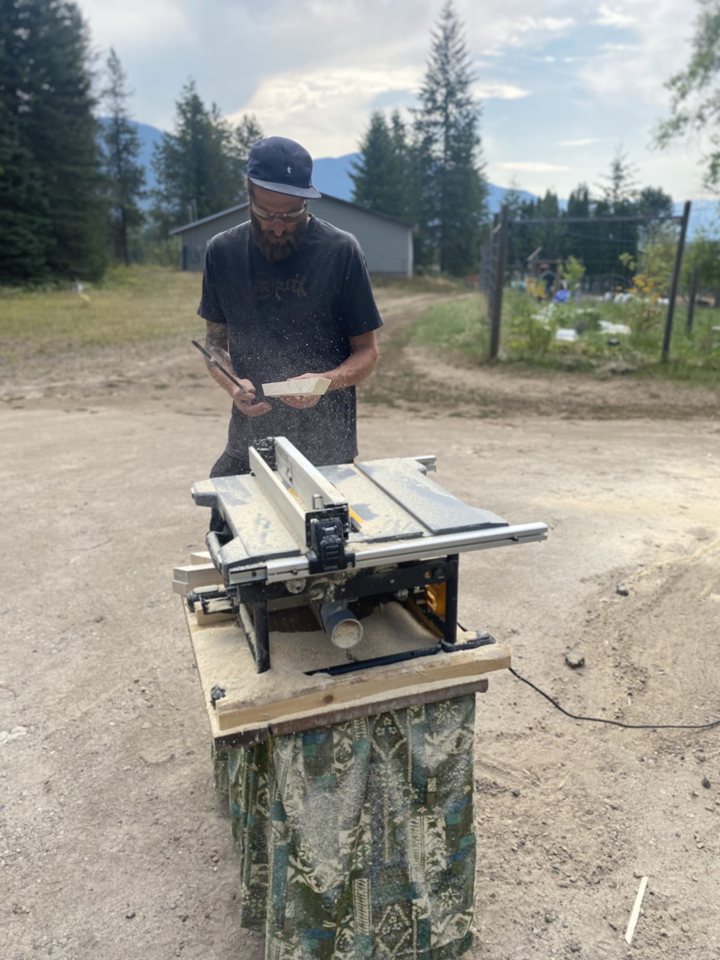 Ripping cedar on the table saw, Slocan Valley in the background