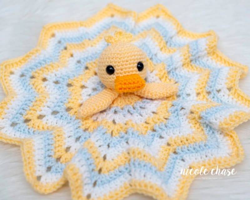 ## Hug Me Duck Lovey in Nursery Colors