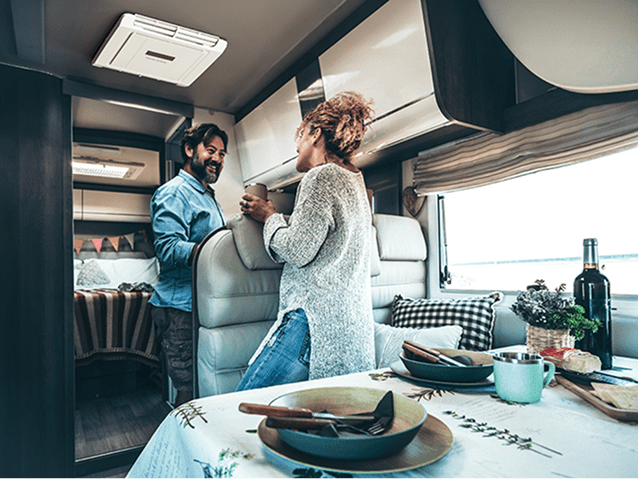 Couple relaxing inside a cool, comfortable RV interior