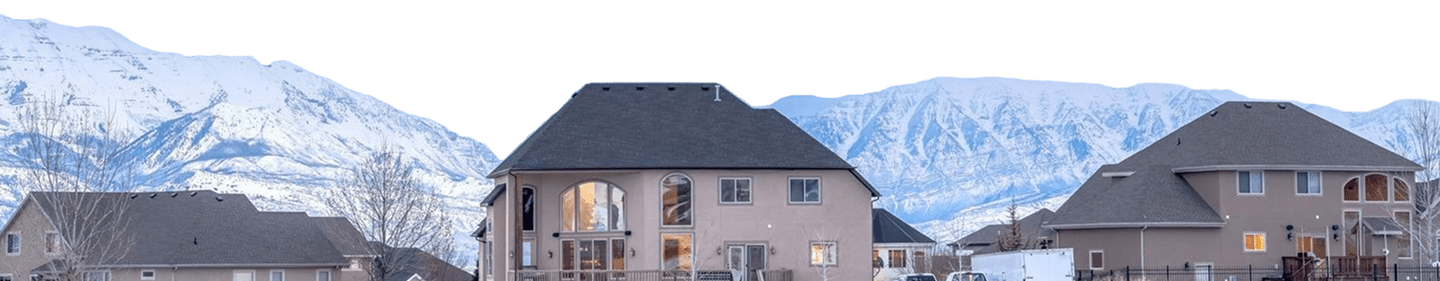 snow covered houses trees against sky