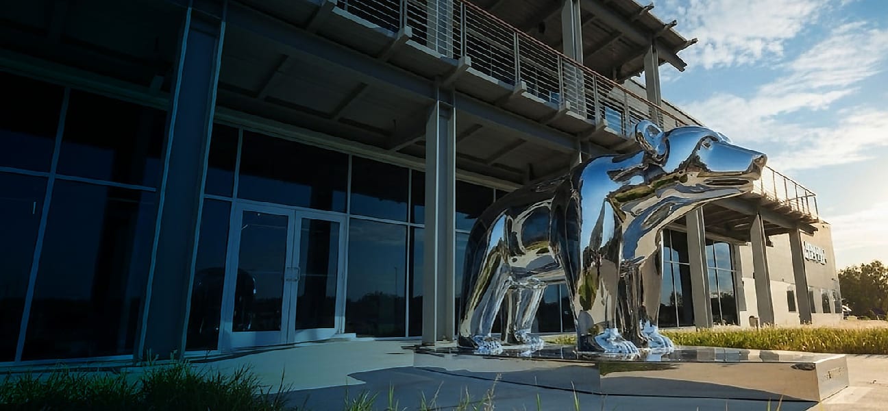 Large chrome bear sculpture in front of the MRCOOL headquarters building