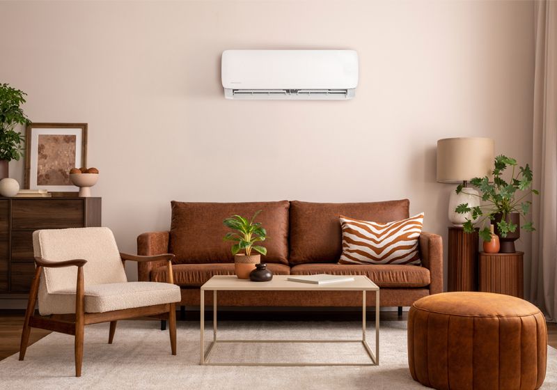 Image DIY® Easy Pro® air handler on a wall above the sofa in a living room.