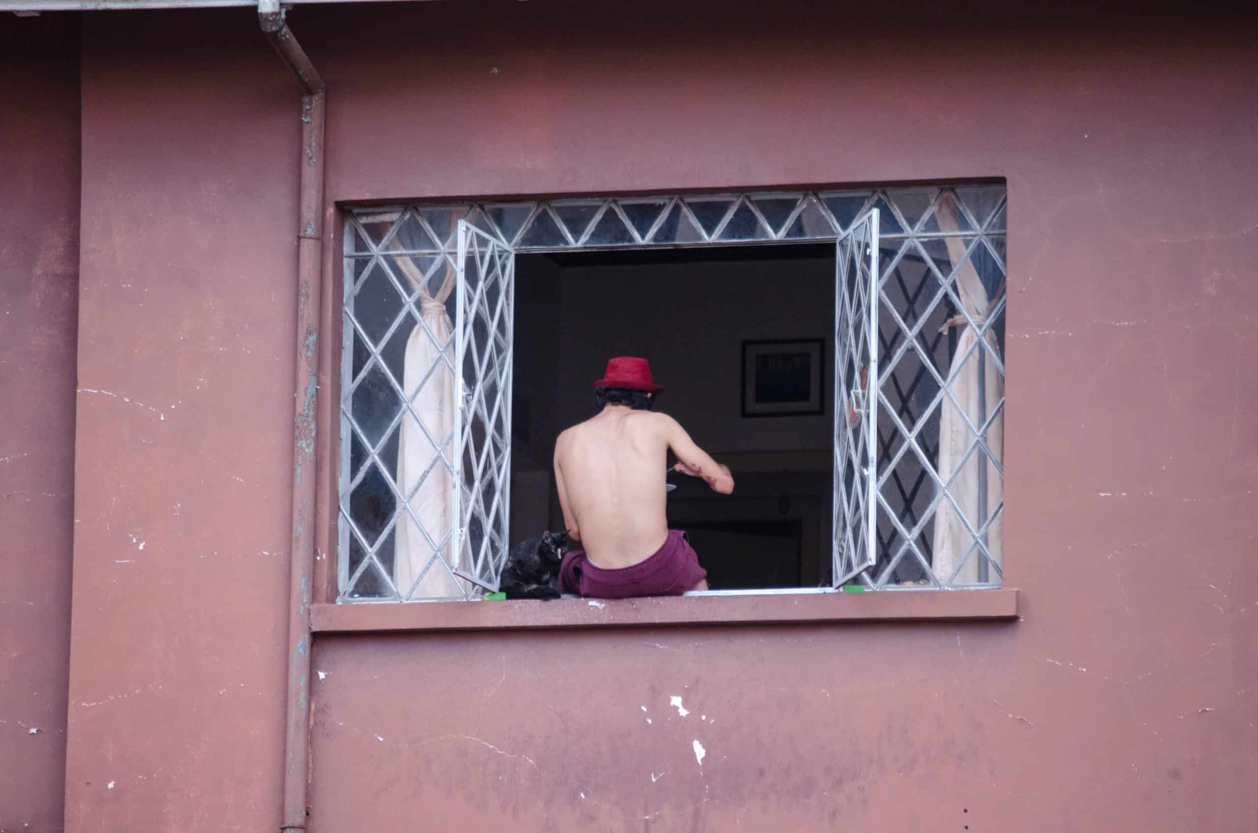 Man sitting on window sill