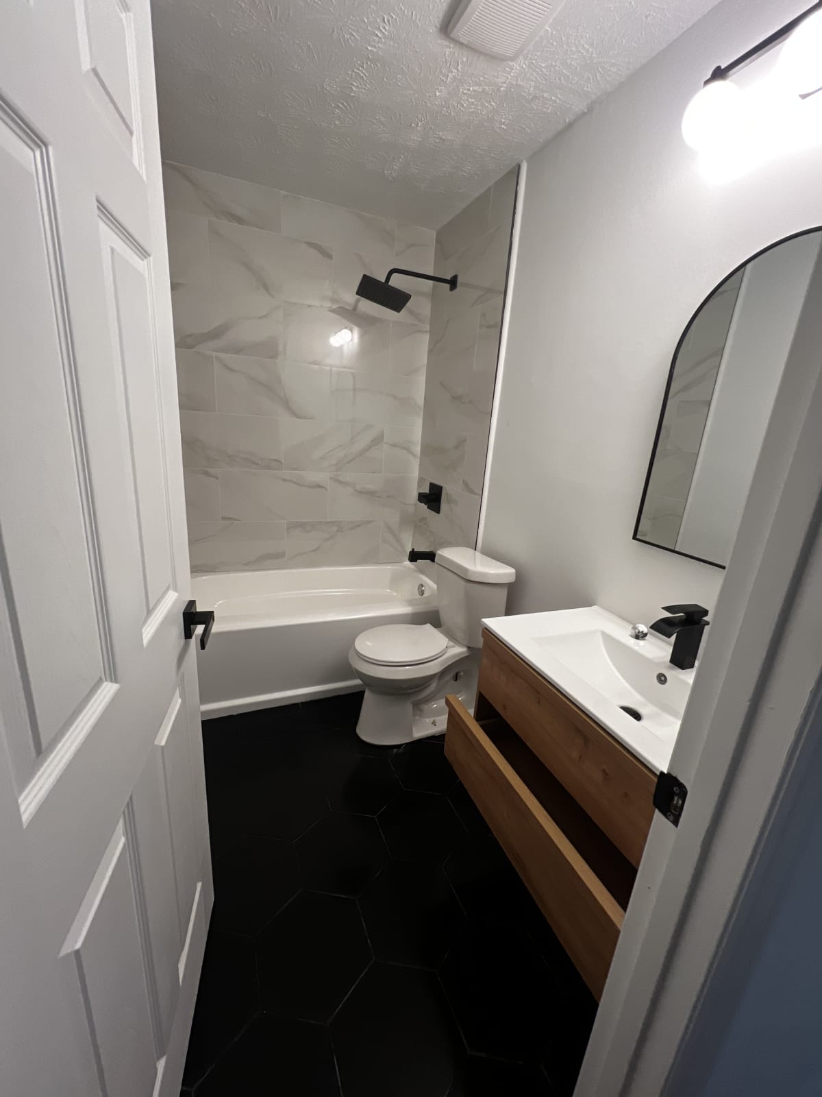 Updated bathroom with new vanity, quartz countertop, and modern lighting after remodel - Atlanta metro project 3