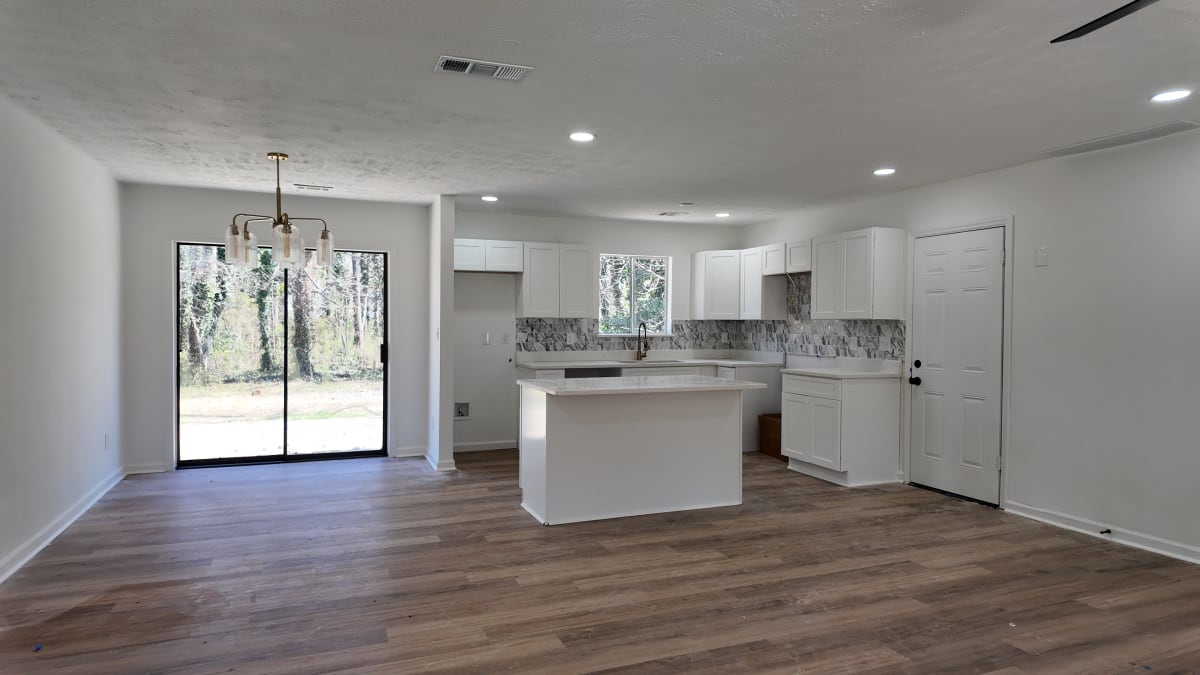 Open kitchen with coordinated finishes and pendant lighting after remodel - Atlanta metro project 4