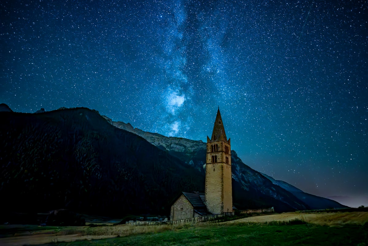 Astrophotographie : la voie lactée au dessus du Queyras, premier plan l'église de Ceillac