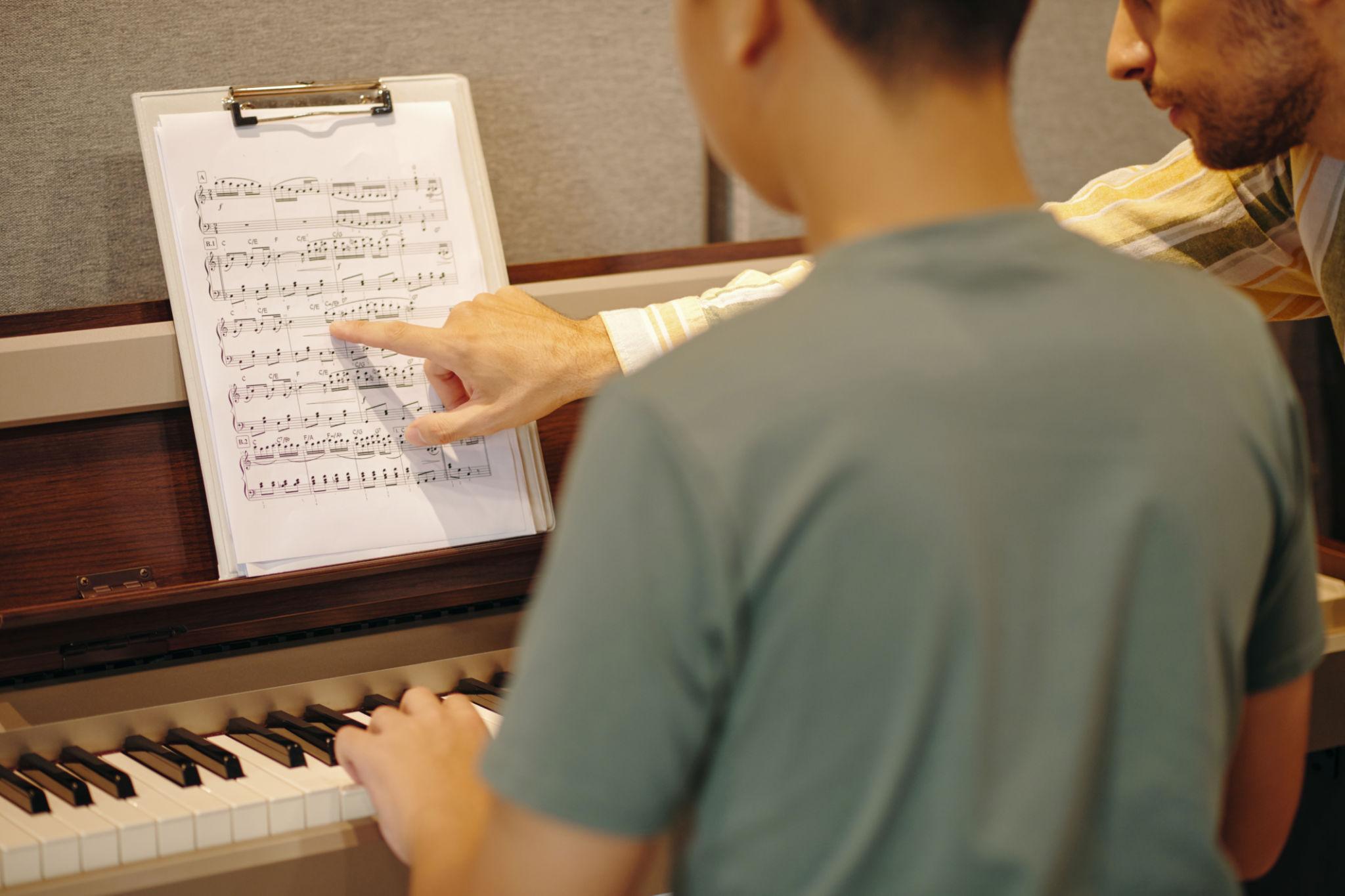 Music teacher working with student