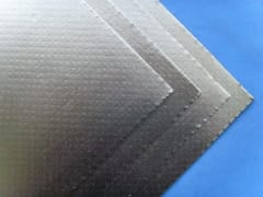 Ceramic fiber board with aluminum foil facing, showing stacked sheets of insulation material.