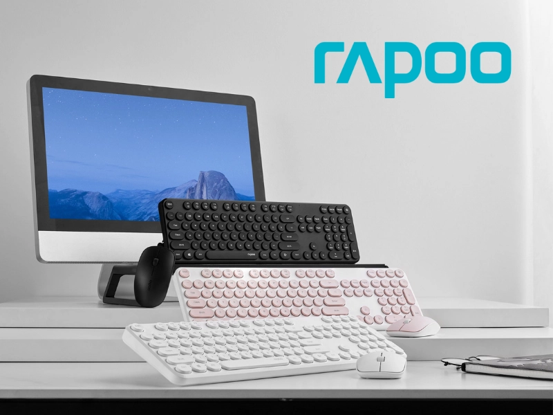 Rapoo computer peripherals including keyboards and a mouse displayed beside a desktop monitor with the Rapoo logo.