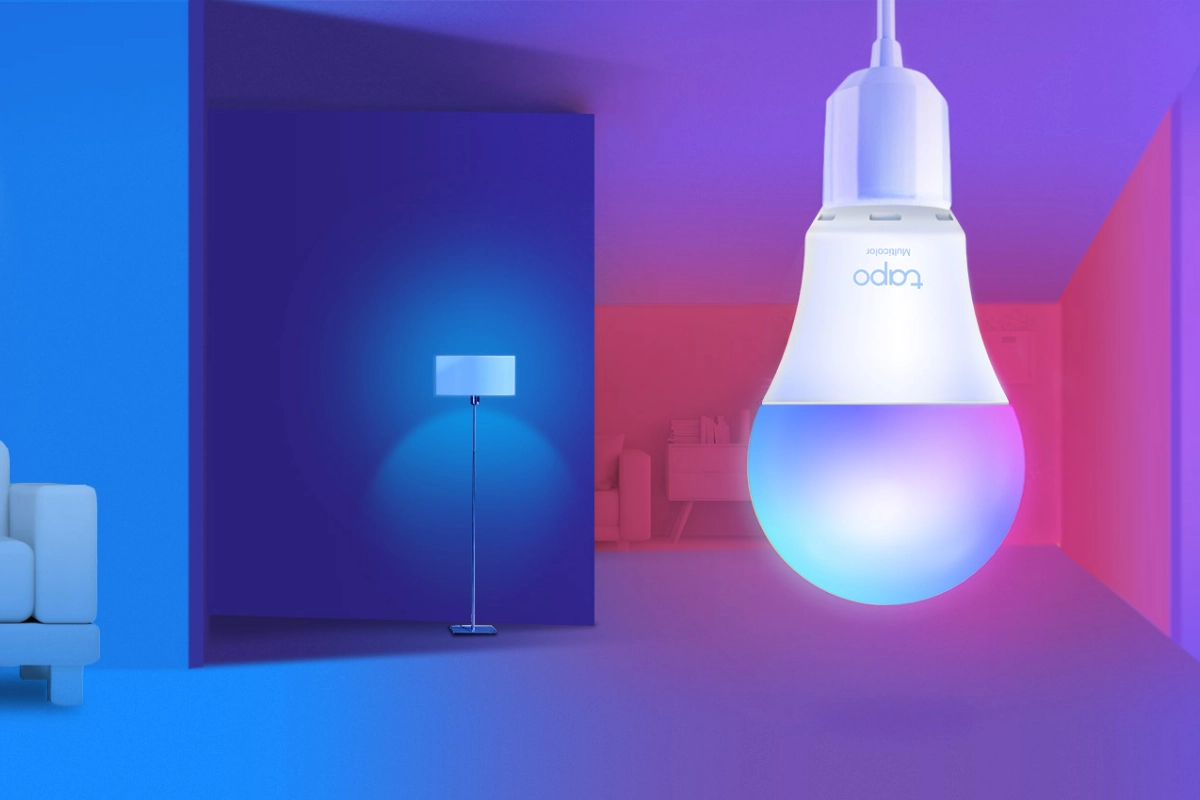 A smart bulb glows with blue and pink hues, illuminating a modern room with a sleek floor lamp and minimalist sofa, creating a futuristic ambiance.