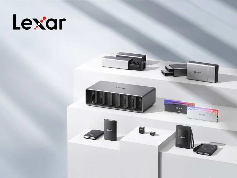 A display of various Lexar products, including a professional drive enclosure, external SSDs, USB drives, and RGB RAM modules, arranged on white steps.