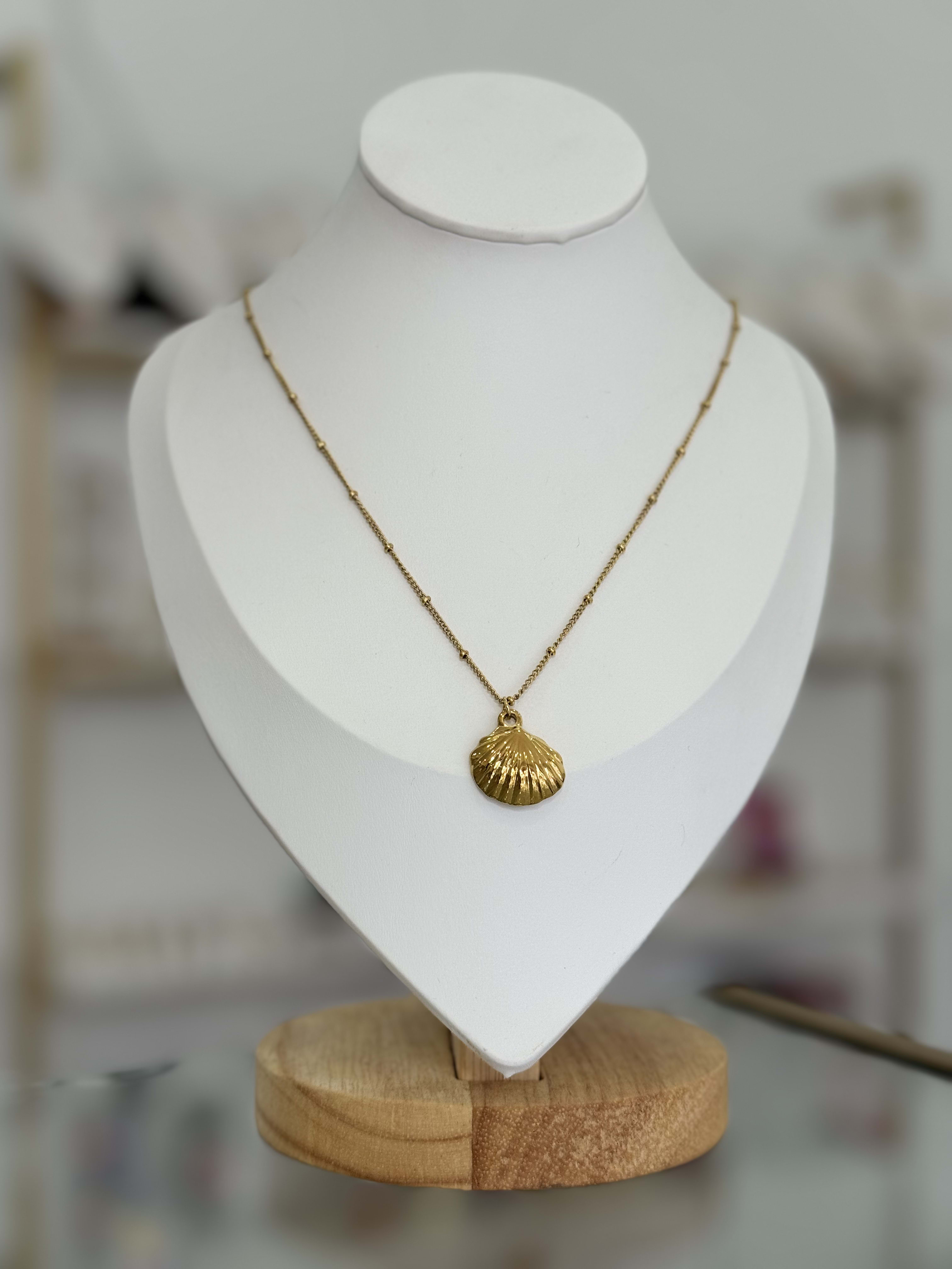 Collar cadena con bolitas y dije de concha marina.