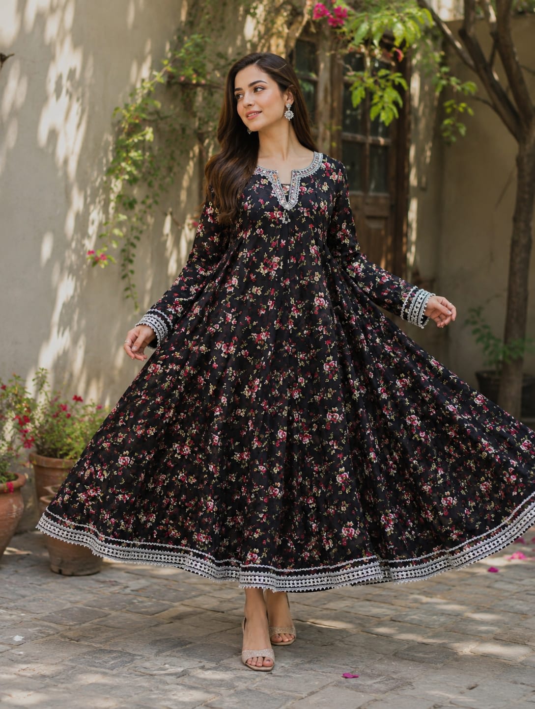 Long black printed kalidaar frock with heavy silver embellishments and lace borders