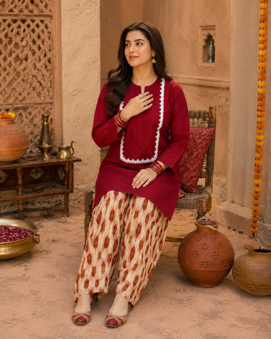 Close-up view of the white neckline lace detailing on a solid maroon women's kurta