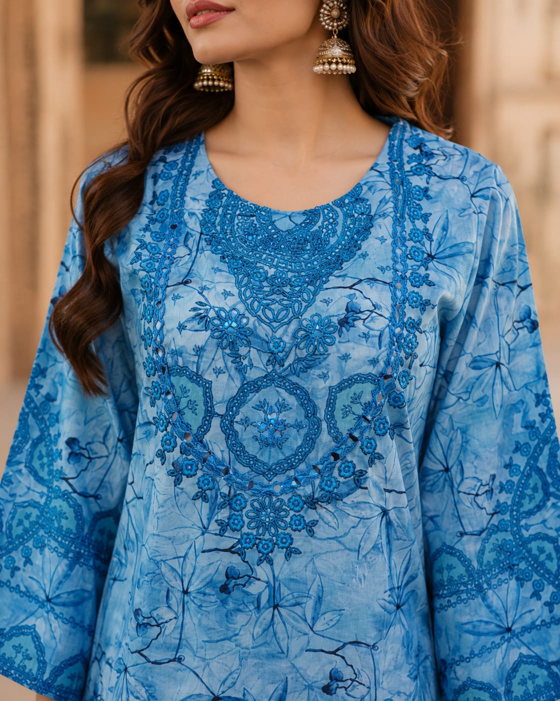 Full length front view of a model wearing a monochromatic blue printed and embroidered lawn suit with wide-leg trousers