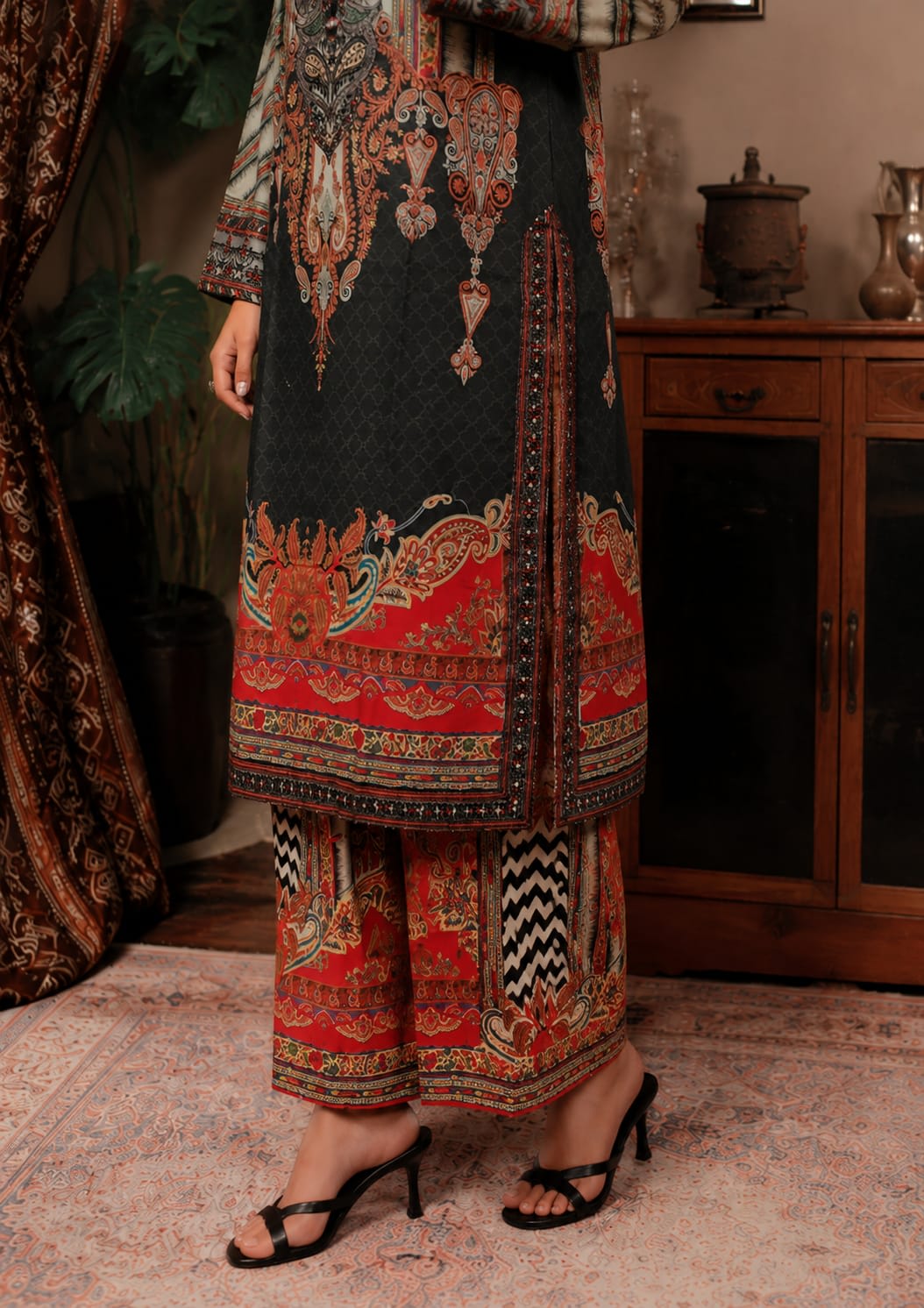 Full length front view of a model wearing an emerald green 3-piece printed floral lawn suit with a matching dupatta