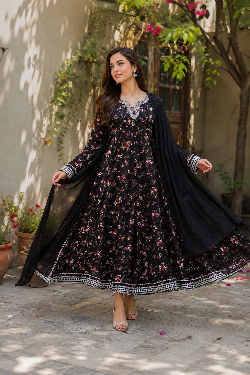 Long black printed kalidaar frock with heavy silver embellishments and lace borders