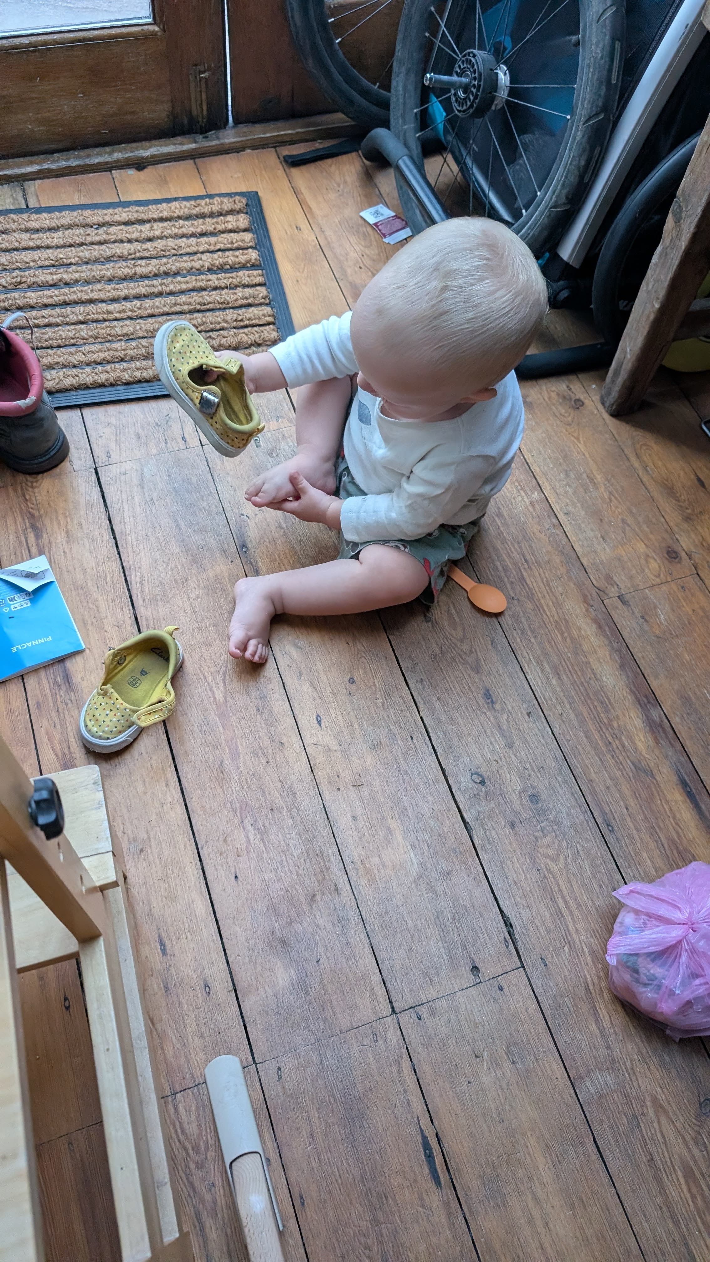 Pemi likes wearing shoes and is learning how to put them on