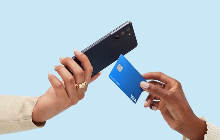A hand swiping their credit card