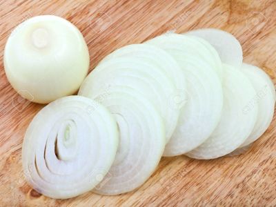 23504088 onion bulb and sliced onions on wooden cutting board close up