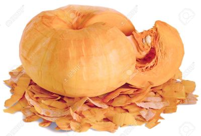 96643392 a piece of peeled cut from a whole fruit ripe orange pumpkins with white seeds horizontal close up l