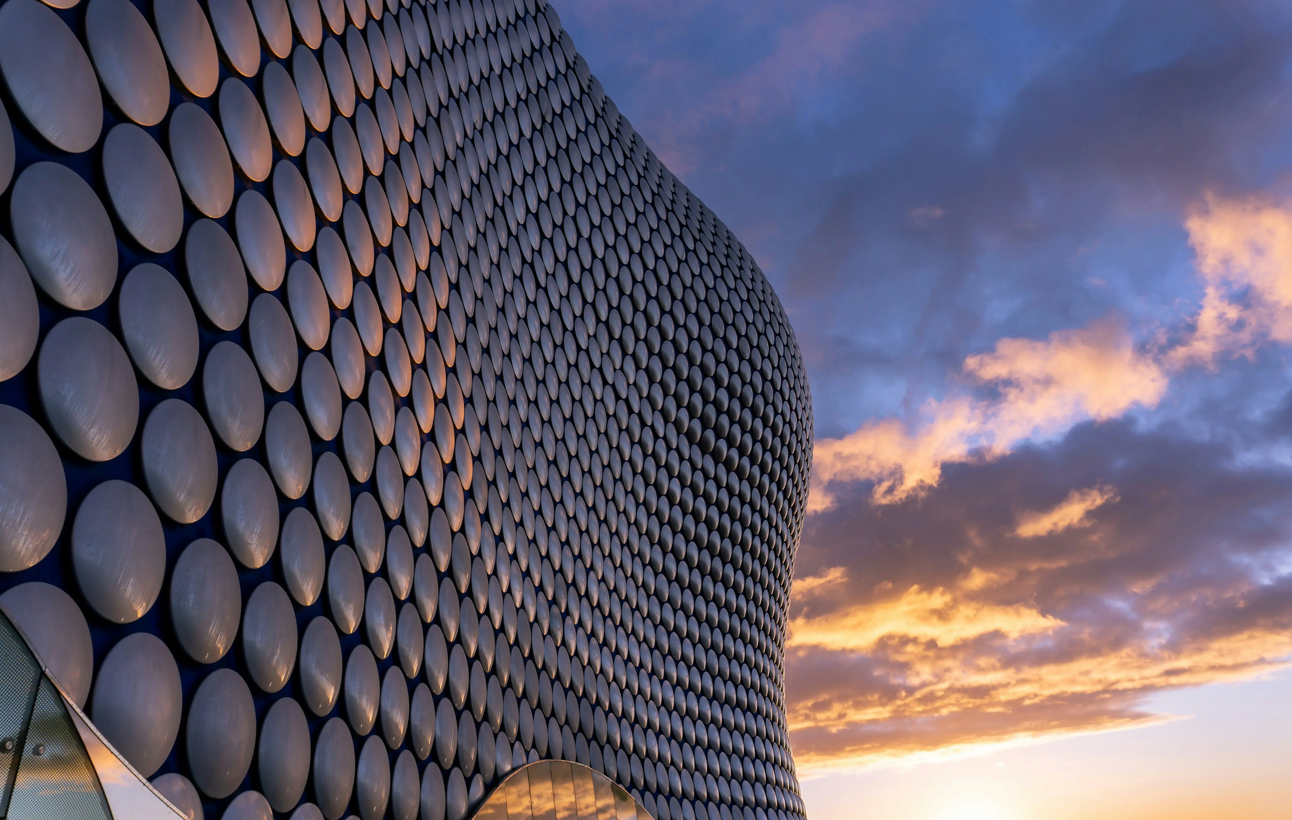 Close-up of Birmingham Selfridges building at sunset with dramatic sky