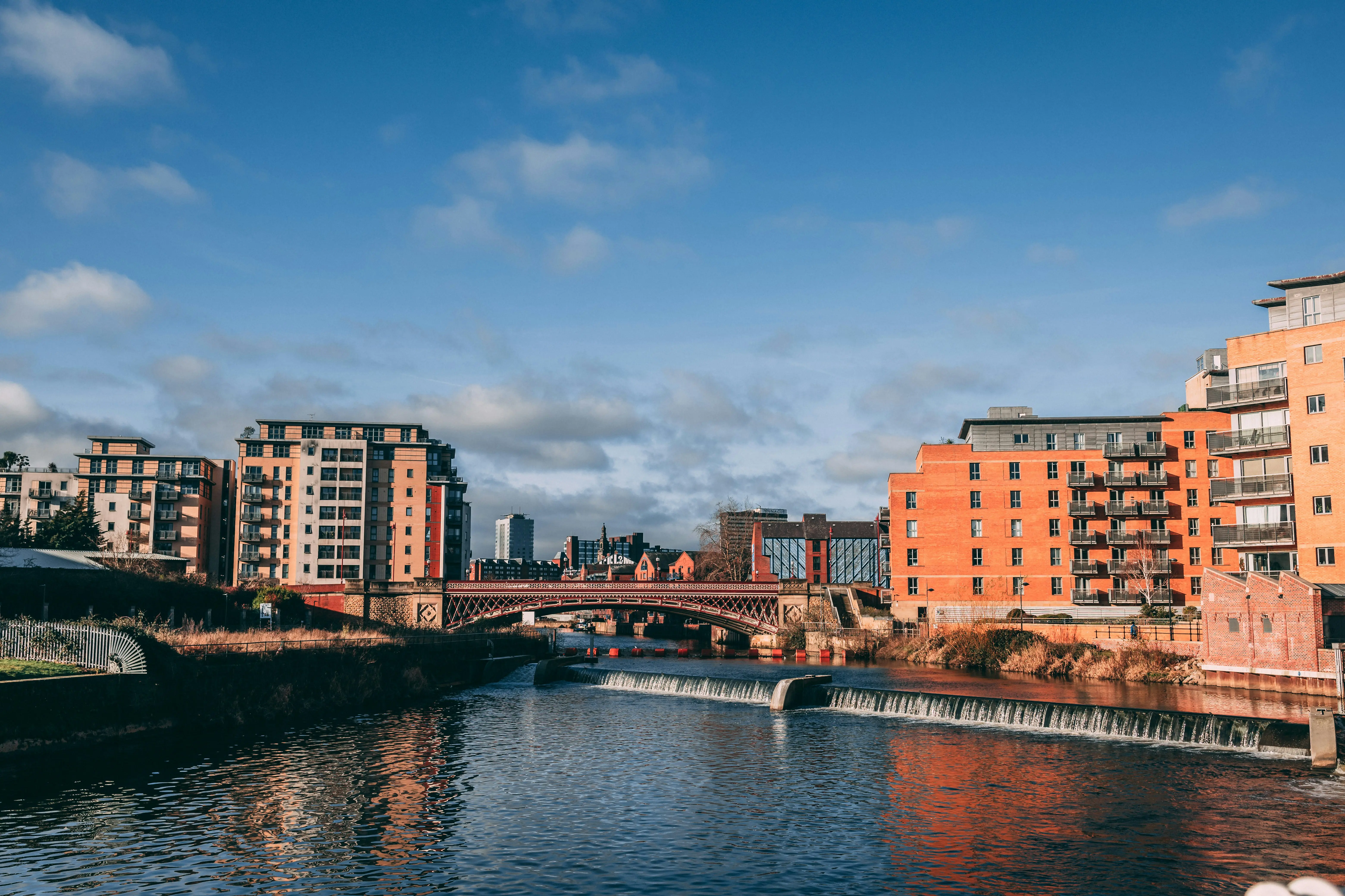 Leeds city waterfront with modern apartments and historic bridge