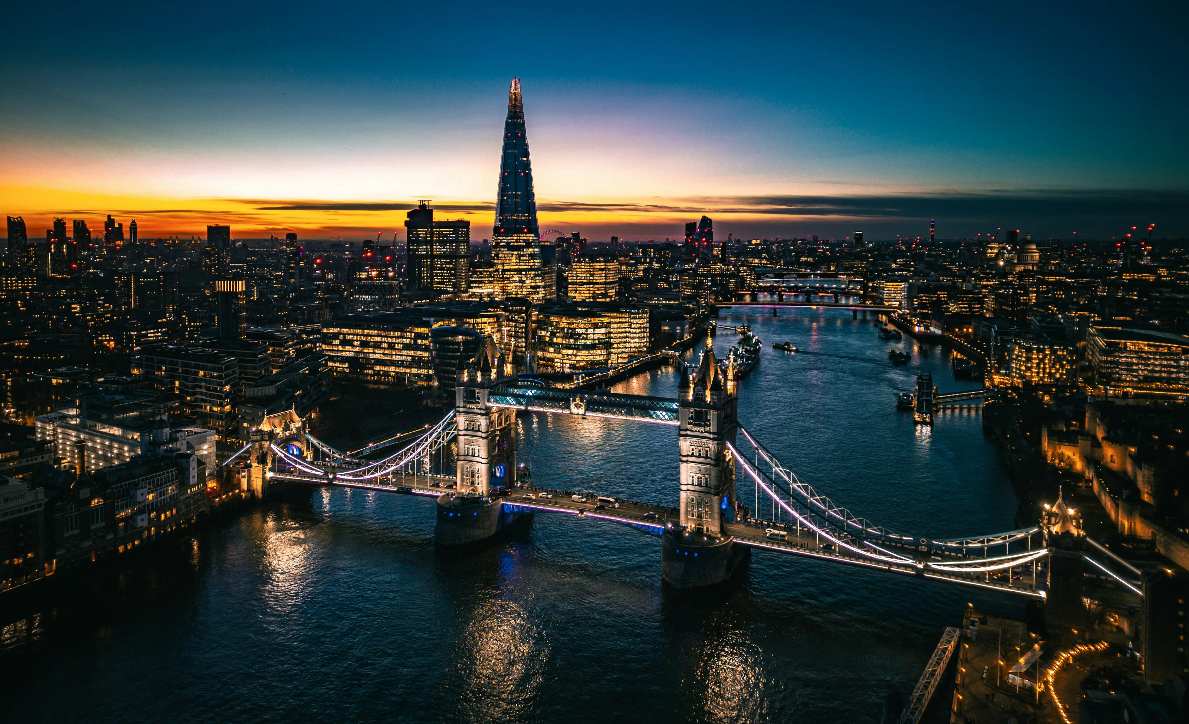 London skyline at sunset with illuminated Tower Bridge and The Shard