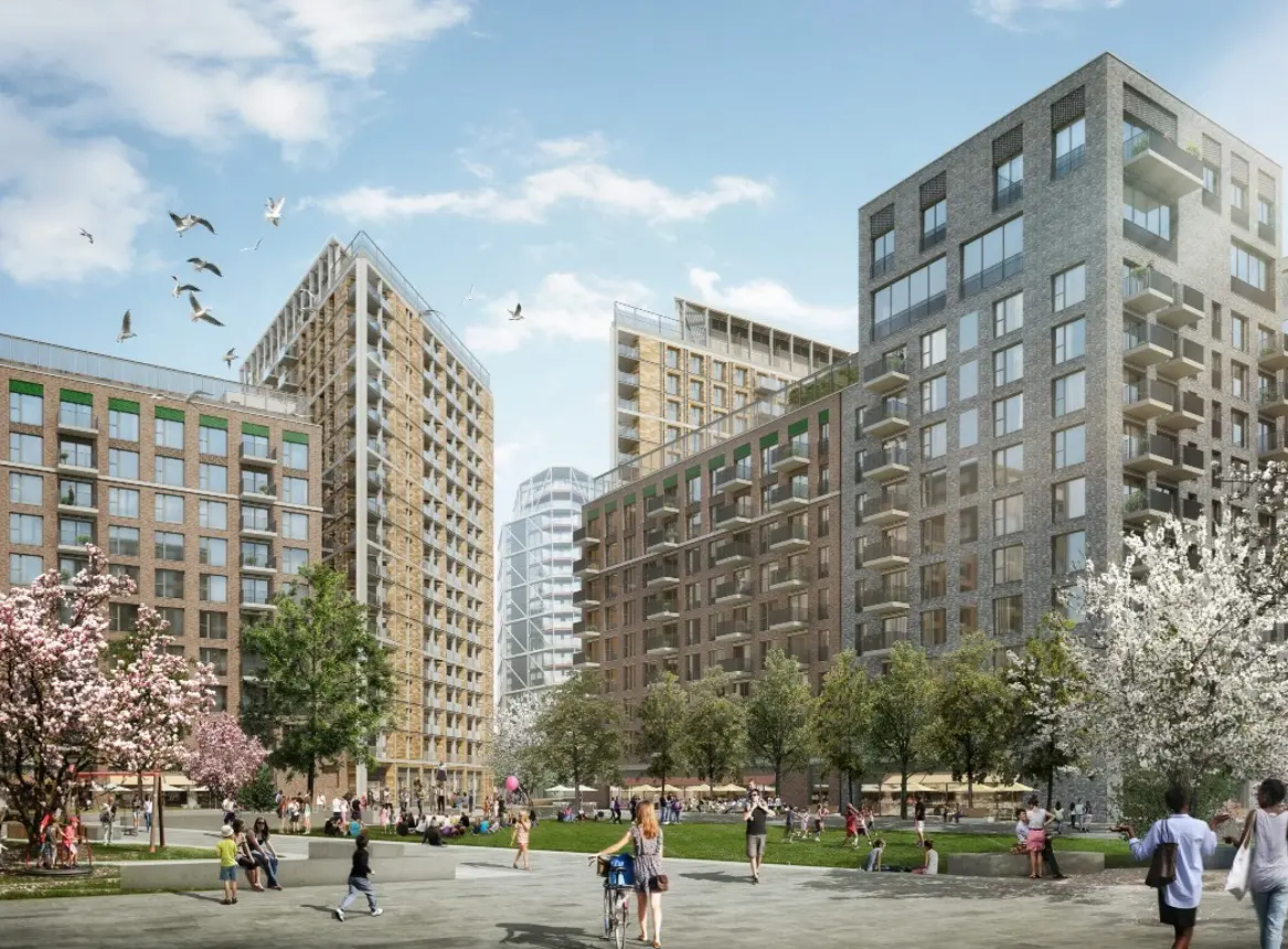 Residents enjoying the landscaped public green space surrounded by modern apartment buildings at Bloom Nine Elms