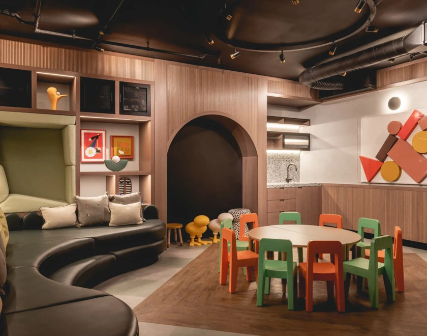 Thumbnail Bloom Nine Elms kids play area with colorful chairs, play furniture, and cozy seating