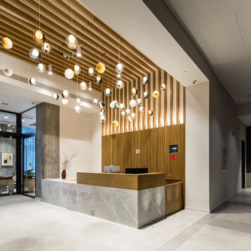 Thumbnail Reception area at Bloom Nine Elms with modern lighting and wood panel detailing