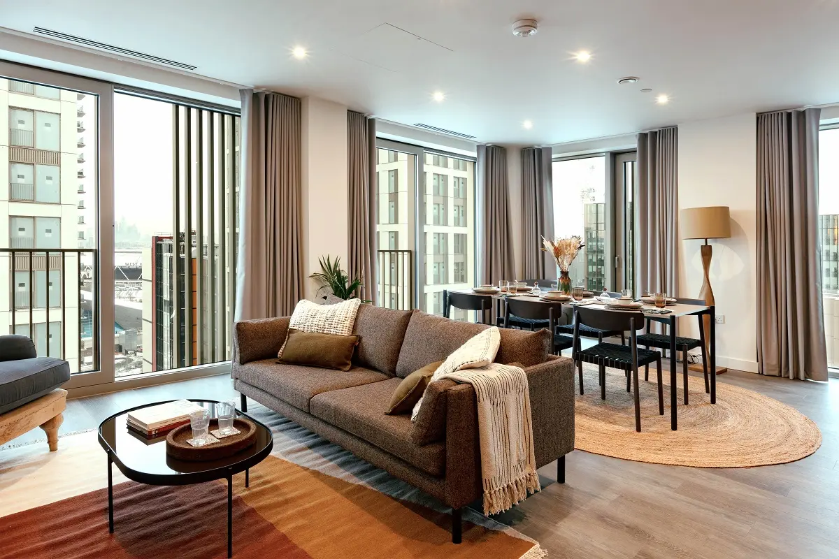 Thumbnail Modern living and dining area in a Coppermaker Square apartment with large windows and contemporary furnishings