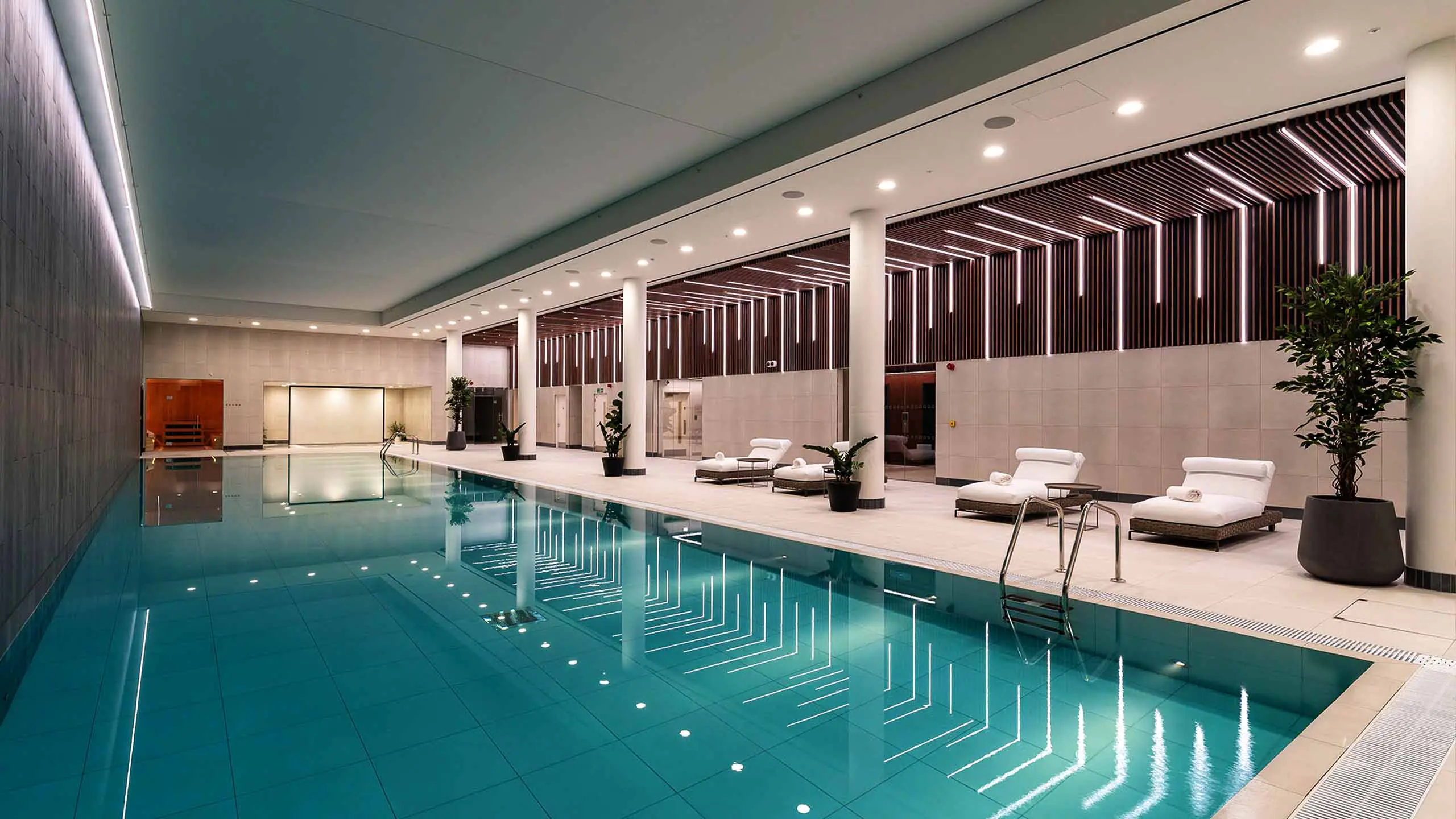 Thumbnail Luxury indoor swimming pool with loungers and modern lighting at Coppermaker Square