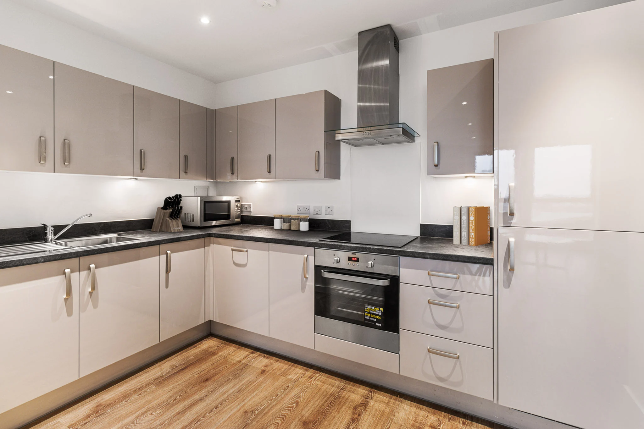 Thumbnail Gloss-finish kitchen at Fizzy East16 with integrated appliances and wood flooring