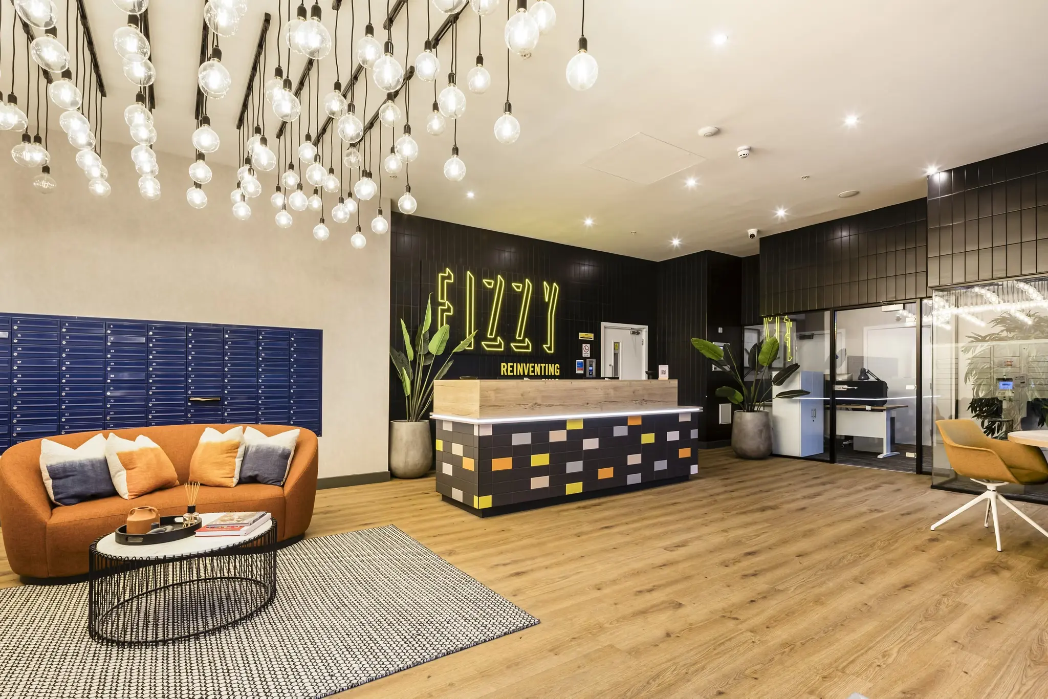 Thumbnail Stylish lobby at Fizzy East16 with neon signage lounge seating and hanging lights