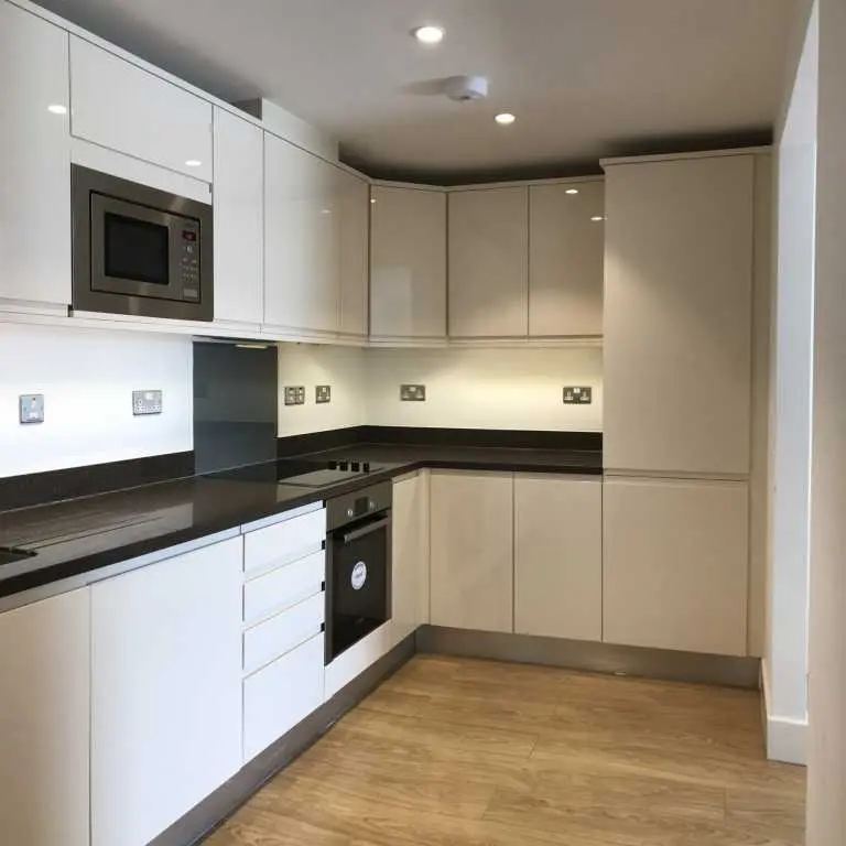 Thumbnail Modern U-shaped kitchen at Fizzy Epsom with glossy cabinets and built-in appliances