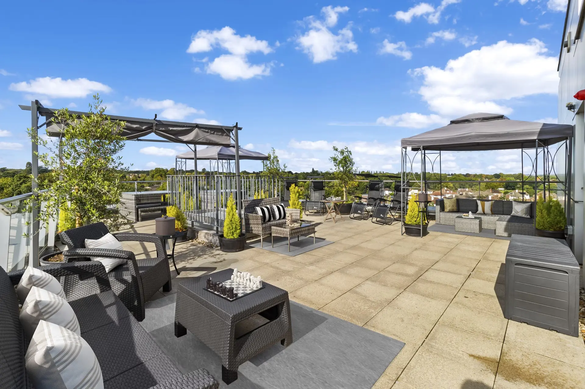 Thumbnail Fizzy Epsom rooftop communal terrace with outdoor seating, parasols, and scenic views