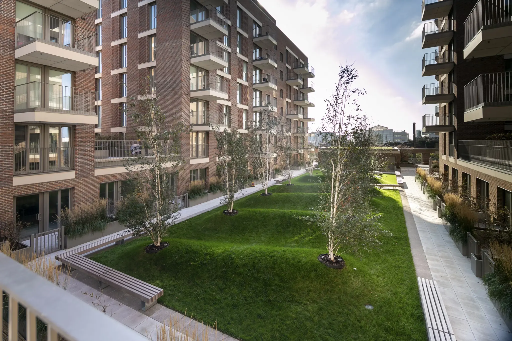 Fizzy Hayes exterior of modern apartment complex with landscaped courtyard