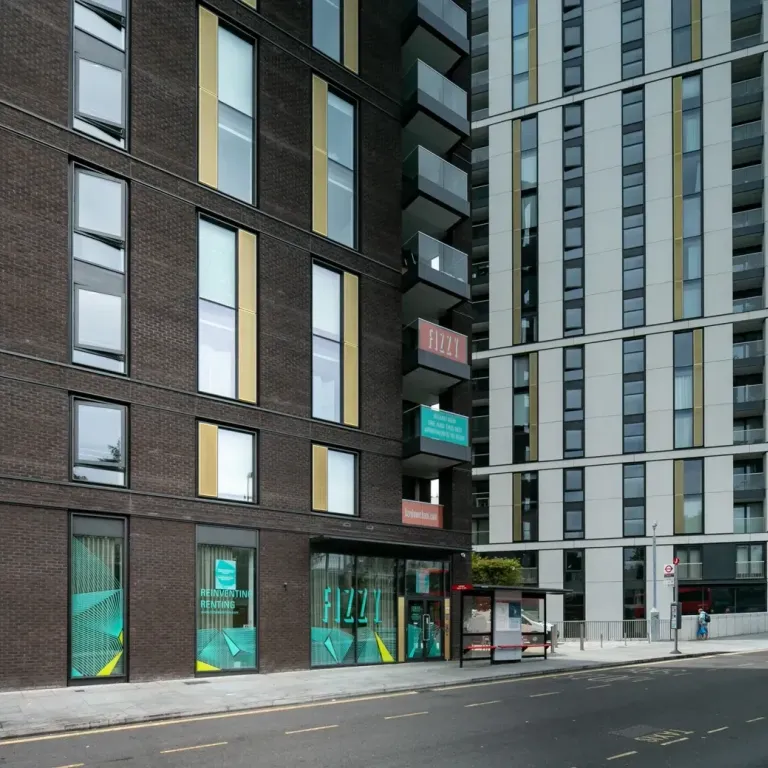 Exterior view of Fizzy Lewisham building with street-level entrance and modern high-rise architecture