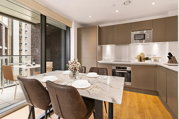 Thumbnail Stylish kitchen and dining area at Fizzy Lewisham with marble table, brown cabinetry, and balcony access