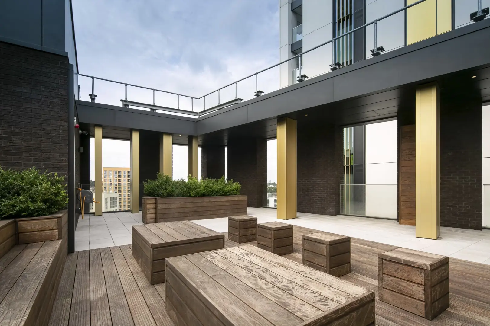 Thumbnail Rooftop communal terrace at Fizzy Lewisham with wooden seating, planters, and city views